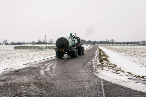 Preview: Tractor With A Barrel Of Sewage Goes Into The Distance. Spring Field Work