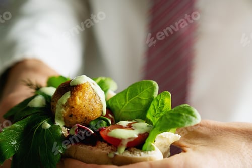 Preview: Man In Corporate Clothes, Office Worker, Eating Falafel Sandwich, Vegan Lunch, Israeli Meal. Vegan