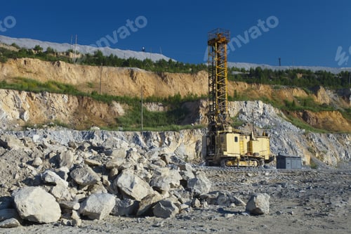 Preview: Quarry Drilling Rig Standing Inside The Quarry On The Background Of Debris Of Rock And Blue Sky.