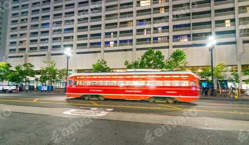 Preview: Red Tram Along City Streets At Night