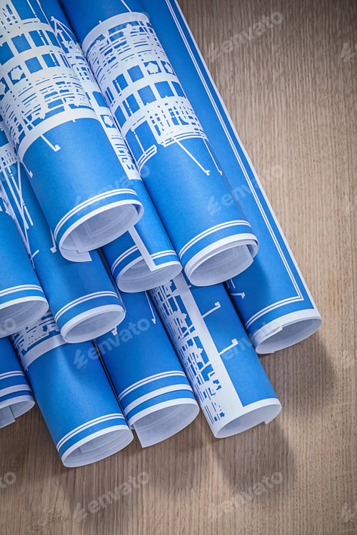 Preview: Blue Blueprint Rolls On Wooden Board Construction Concept.