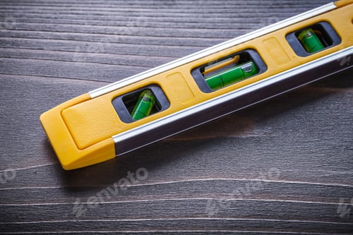 Preview: Close Up Of Yellow Construction Level On Vintage Wooden Board Maintenance Concept.