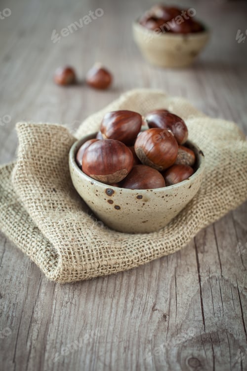 Preview: Bunch Of Fresh Chestnuts In A Bowl On Wooden Table