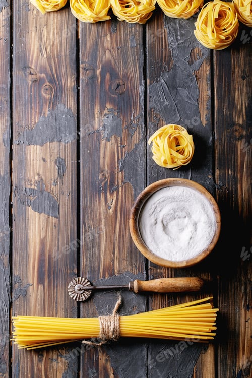 Preview: Raw Ingredients For Cooking: Italian Spaghetti Pasta And Flour Over Dark Wooden Background. Top