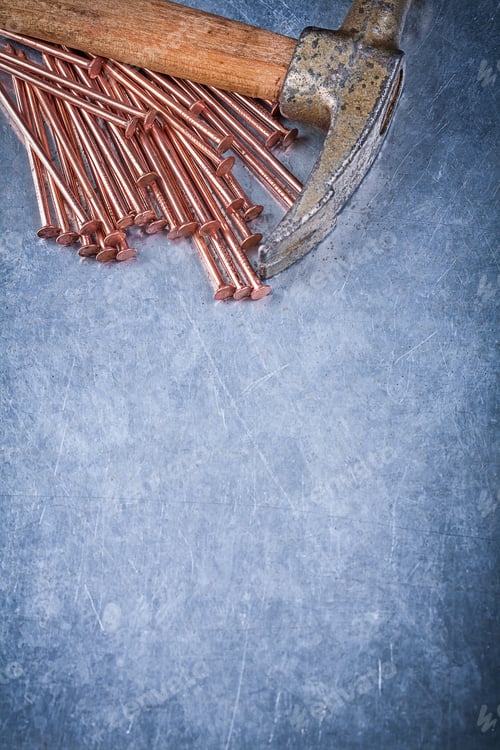 Preview: Set Of Copper Construction Nails Vintage Claw Hammer On Metallic Background.