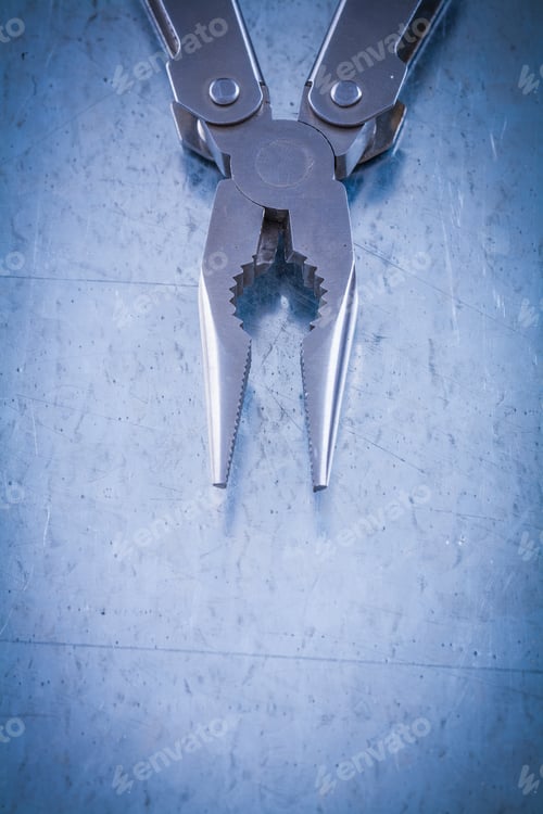 Preview: Metal Nippers On Scratched Metallic Surface Construction Concept.