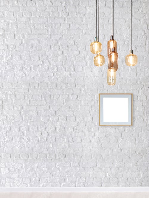 Preview: Stylish Lighting and a Blank Frame Against Brick