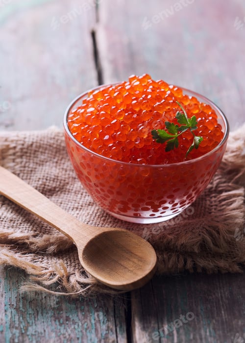 Preview: Red Caviar In Bowl On Aged Wooden Background. Selective Focus.