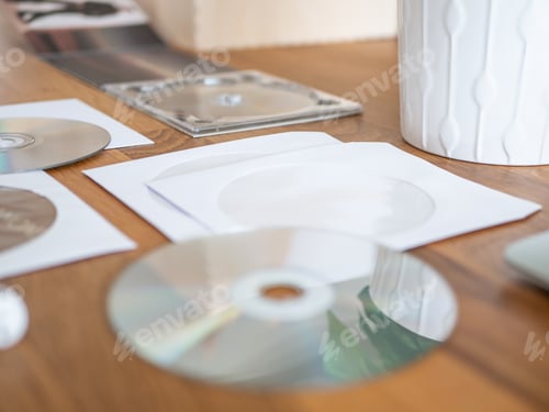 Preview: Cd And White Envelope On The Desk.