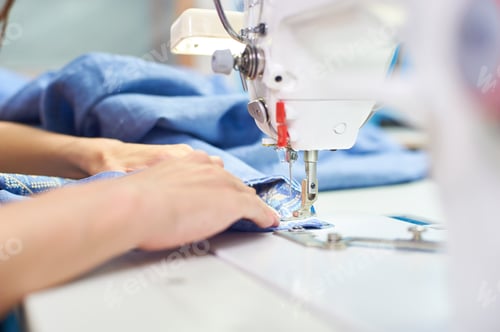 Preview: Industrial Sewing Machine And Hand Seamstress. Close-Up.