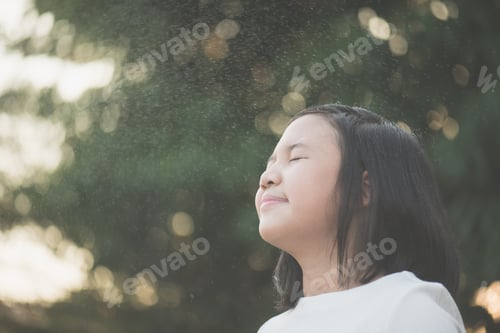 Preview: Portrait Of Beautiful Asian Girl With Closed Eyes Under The Rain