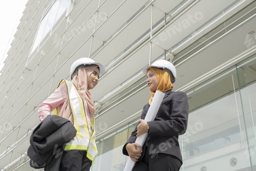 Preview: Business Woman Engineer Developer Holding Blueprint At Site.
