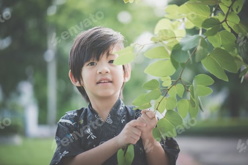 Preview: A Little Lovely Boy In A Kimono Playing In A Park On A Sunny Summer Day