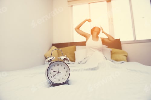Preview: Women And Old Alarm Clock Stretching Hands After Wakeup In Bed, Shallow Depth Of Field Focus On