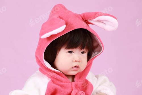 Preview: Baby Dressed In Easter Bunny Ears With Carrot