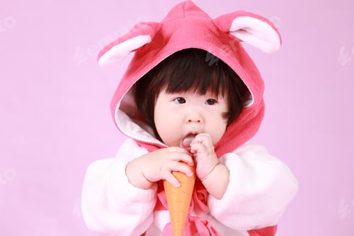 Preview: Baby Dressed In Easter Bunny Ears With Carrot