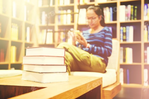 Preview: Books Stacked And Blurred Of Women Using Smartphone With Many Old Books On Bookshelf In