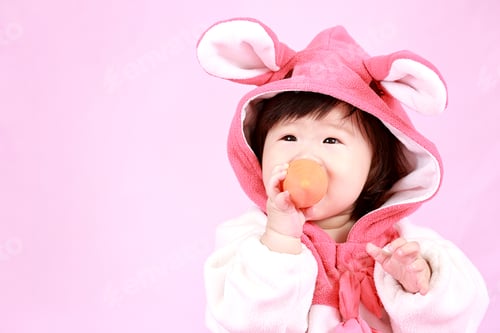 Preview: Baby Dressed In Easter Bunny Ears With Carrot