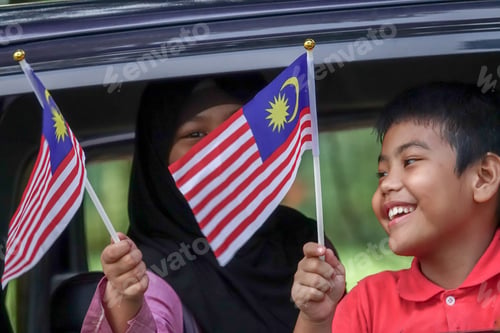Preview: Independence Day Concept -Asian Sibling Cheerful In A Car Holding A Malaysian Flags.