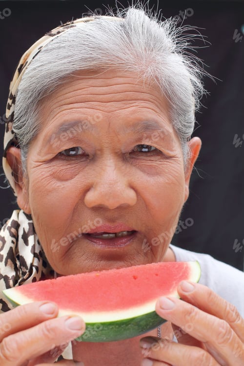 Preview: Portrait Of Senior Woman Eating Melon