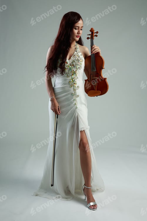 Preview: Southeast Asian Violinist, Young Beautiful Asian Woman Playing Violin On Gray Background.