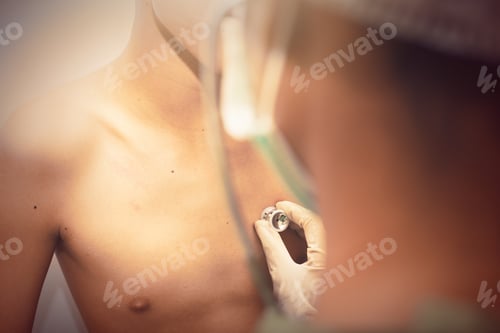Preview: Female Doctor'S Face Wearing Protective Mask And Green Surgeon'S Cap With A Stethoscope. Checking