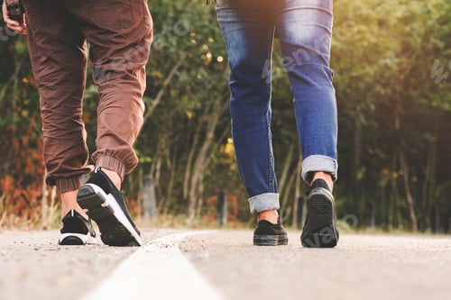 Preview: Young Couple Traveler With Backpack Enjoying And Walking On The Road In Tropical Forest, Thailand