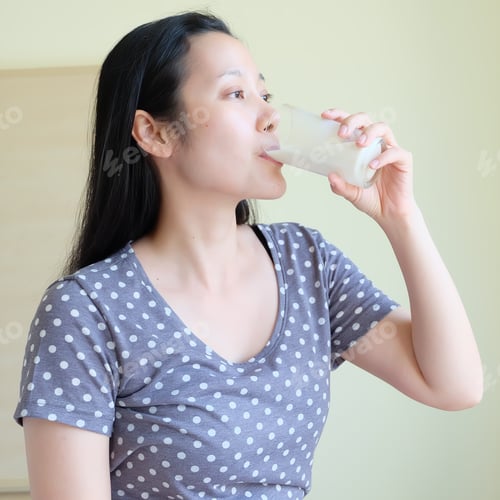 Preview: Asian Woman Is Drinking Milk From A Glass
