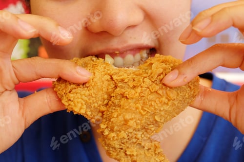 Preview: Young Woman Holding And Eating Fries Chicken