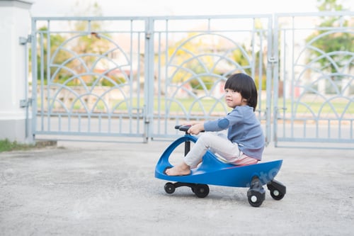Preview: Cute Asian Child Driving Blue Toy Car Outdoors