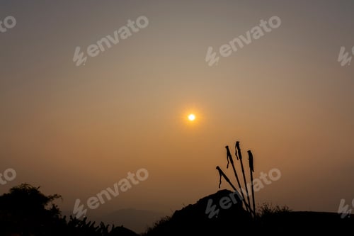 Preview: Silhouette Group Of Trekking Sticks Poles On A Mountain Top Peak Background. Beautiful
