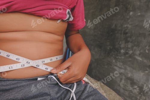 Preview: Boy Belly Fat With Tape Measure Weight Loss Around Body On Black Background. Healthy And Lose
