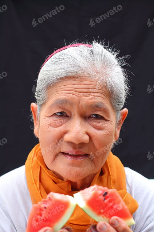 Preview: Portrait Of Senior Woman Eating Melon
