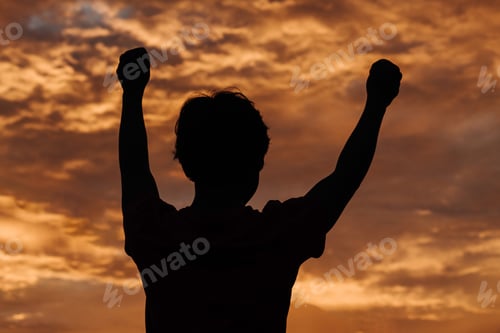 Preview: Silhouette Of A Kid Raising His Arms In Front Of The Beautiful Sunset