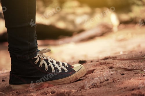Preview: Traveller Feet In Sneakers Surrounded At Natural Beauty, Concept Travel, Color Of Vintage Tone And
