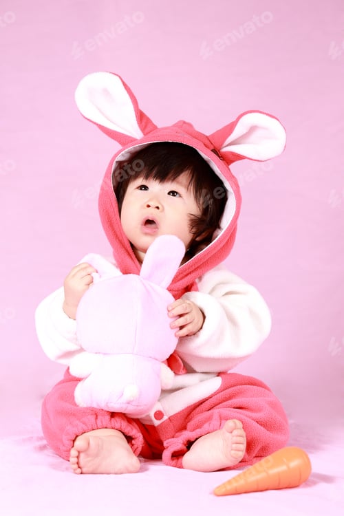 Preview: Baby Dressed In Easter Bunny Ears With Carrot