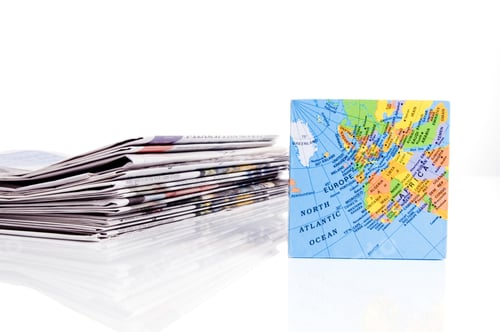Preview: A Map Of Europe And Africa Beside A Pile Of Folded Papers.