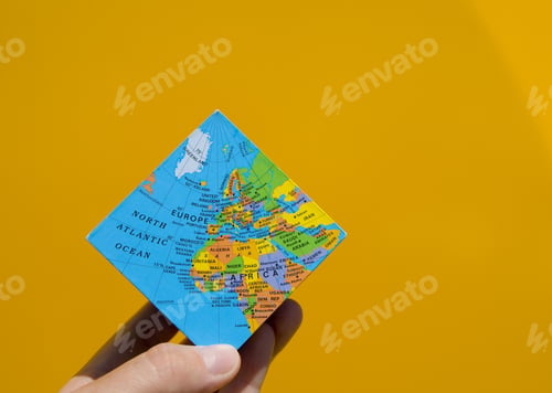 Preview: A Hand Balances A Square Globe On The Tips Of Its Fingers.