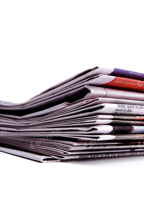 Preview: A Stack Of Newspaper Sections With Folded Edges Lined Up.
