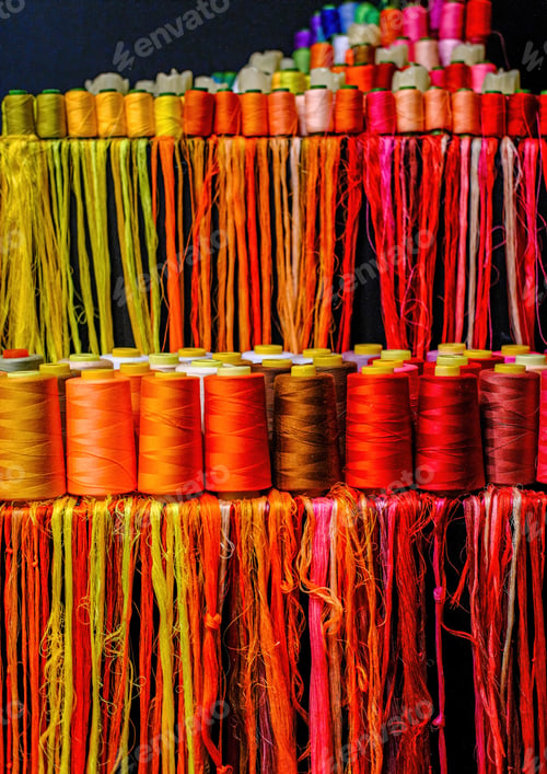 Preview: Orange And Yellow Thread On Spools And Strands