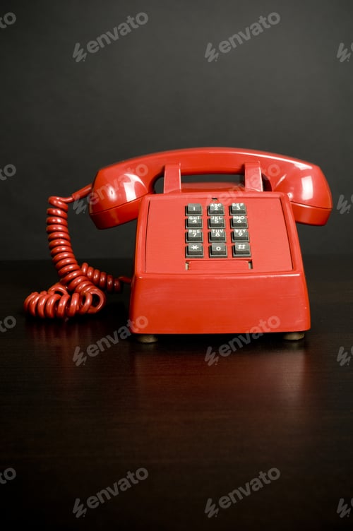 Preview: An Old Red Telephone With Gray Push Buttons.