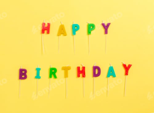 Preview: Happy Birthday Candles On A Yellow Paper Background