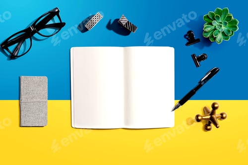 Preview: Notebook With Office Supplies And A Plant - Flat Lay
