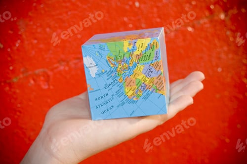 Preview: A Square Cube That Has A Map Of The World On It.