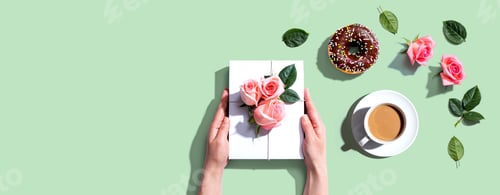 Preview: Female Hands Holding A Gift Box With Pink Roses Overhead View - Flat Lay