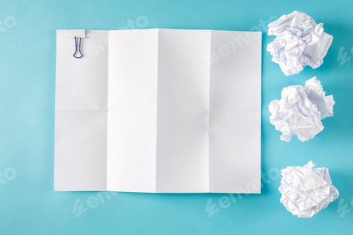 Preview: Blank Paper With Crumpled Paper Balls On A Blue Background