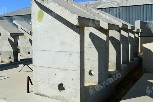 Preview: Precast Concrete Components Of Various Shapes Are Stored In A Yard Awaiting Incorporation Into New
