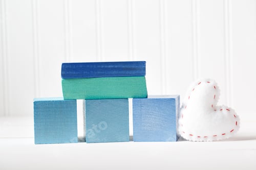 Preview: Blue Wooden Blocks With Heart Cushion On A White Table