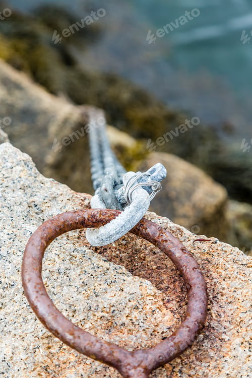 Preview: An Old Rusted Iron Ring And Chain Securing A Ramp To A Pier