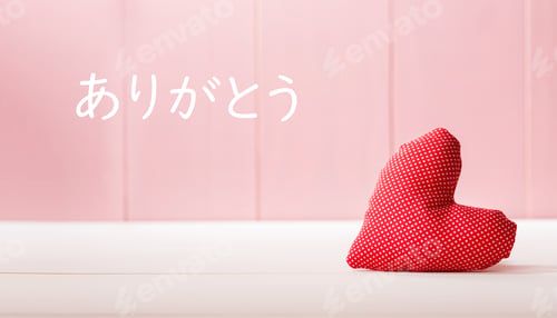 Preview: Arigato - Thank You In Japanese Language With A Red Heart Cushion Over A Pink Wooden Wall